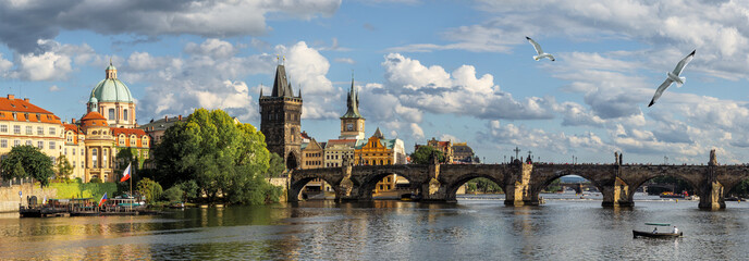 Panoramic landscape of the Old Town of Prague with view of Charles Bridge and Gothic Towers with spires. Wide panorama of Praga historic downtown, Great Medieval Charles Bridge and Vltava River.
