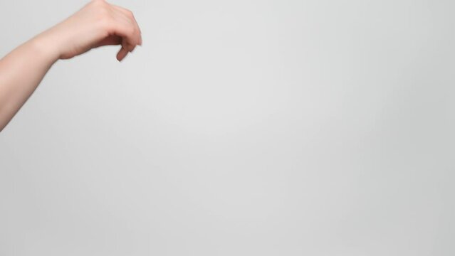 Close up shot of a woman's hand making a flick gesture. 4k, slow motion.