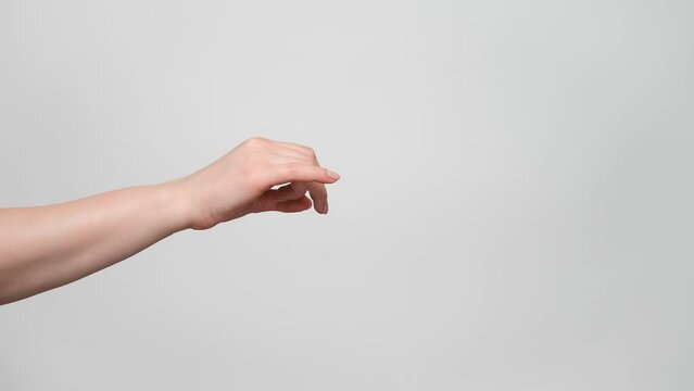 Close up shot of a woman's hand making a flick gesture. 4k, slow motion.