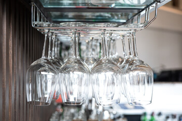 Row of drinking glasswares are prepared on the counter bar, ready for service to customer. Drink object, close-up and selective focus.