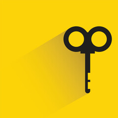 key with drop shadow on yellow background