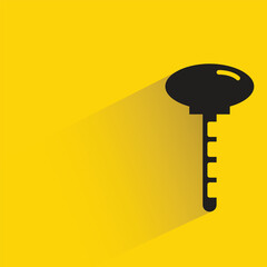 door key with shadow on yellow background