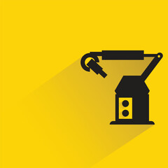 industrial robotic arm with shadow on yellow background