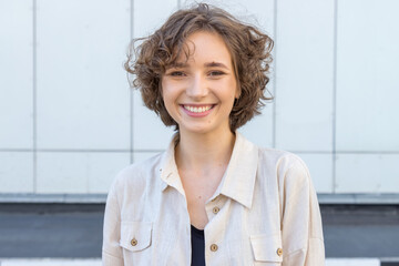 Close-up portrait of a young twenty year old woman looking at the camera.