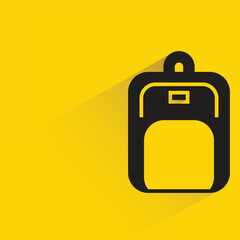 schoolbag with shadow on yellow background