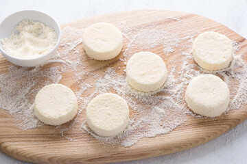Raw keto syrniki with coconut flour on a wooden board