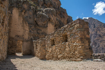 Archaeological site of Ollantaytambo with stone walls with windows and arched doorway, in Peru.