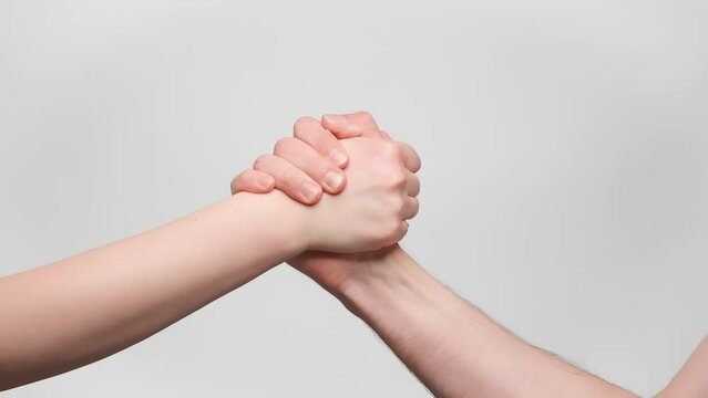 Man and woman shake hands, high five handshake close up. 4k, slow motion.