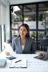 Portrait of young beautiful businesswoman working for her project at the office desk