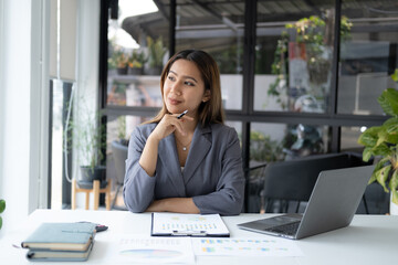 Portrait of young beautiful businesswoman working for her project at the office desk