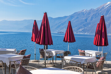 Empty street cafe vith the view to Lago Maggiore on a sunny early spring day - 592323639