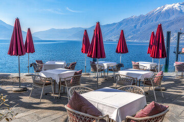 Empty street cafe vith the view to Lago Maggiore on a sunny early spring day - 592323657