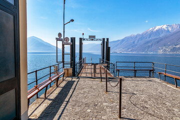 Pier in Ascona on Lago Maggiore in Switzerland. Information tables read in Italian: 