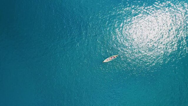 Top view drone view of Parasailing in blue sea in summer season, Aerial view parasailing with a motorboat along the coast in andaman sea