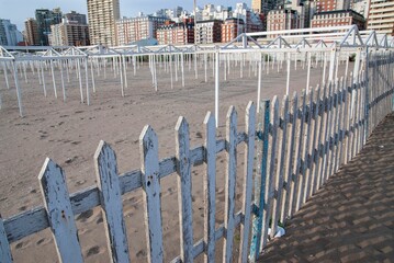 View of an empty square in Mar del Plata, Argentina in daytime with a white and blue fence around