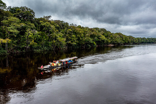 Illegal miners on their boat on the black Pasimoni River, in the deep south of Venezuela