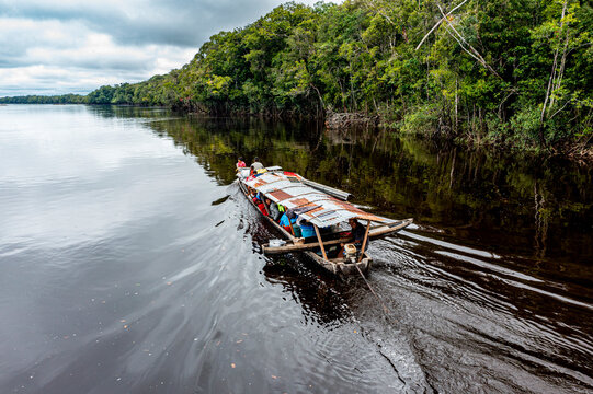 Illegal miners on their boat on the black Pasimoni River, in the deep south of Venezuela