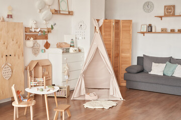 Children's educational wooden toys. Nursery decor. Scandinavian style playroom. Wigwam © Aleksandr