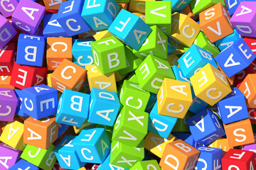 Mess of bright kid colorful cubes with letters.
