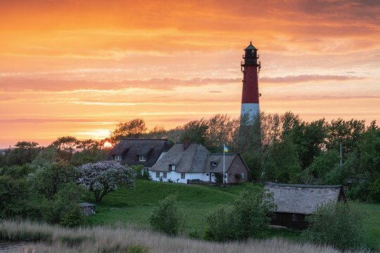 Pellworm lighthouse against the sunrise, North Frisia, Germany