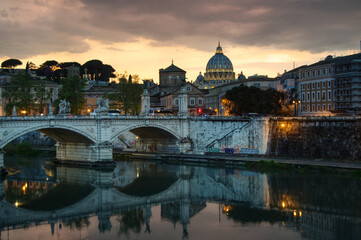 Fototapeta na wymiar sunset on Tiber river and Ponte Vittorio Emanuele II toward Saint Peter's cathedral 