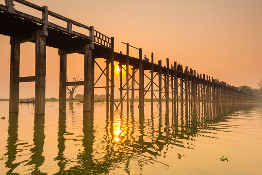 People walking on U-Bein bridge over Taung Tha Man Lake at sunset, Amarapura, Mandalay, Myanmar