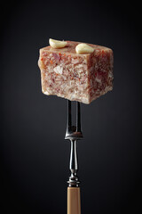 Headcheese on a fork.