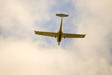 Fototapeta premium One-engine flying under clouds in blue sky