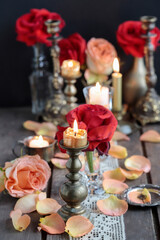 Obraz na płótnie Canvas Romantic table decoration with roses and candles. Valentine's Day decorating ideas.