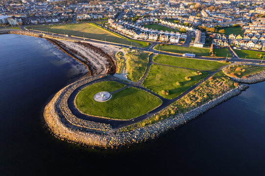 Aerial view on Famine Ship Memorial in Celia Griffin Memorial Park in Salthill area of Galway city, Ireland. Dense residential area in the background.