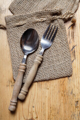Spoon and fork on jute sack.