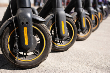 Fototapeta premium Electric scooters are parked in the city center. Modern public mobile transport