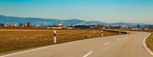 Winter landscape on a sunny day with a sugar factory near Plattling, Deggendorf, Bavaria, Germany