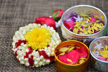 Jasmine water and rose petals in a bowl for Songkran festival in Thailand. with space for text.
