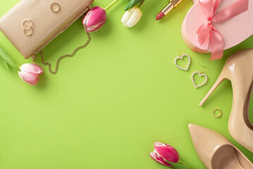 Simple Mother's Day concept. Flat lay of high-heels, handbag, present box, tulips, lipstick, makeup brush, and earrings on pastel green background with an empty area for text or advert