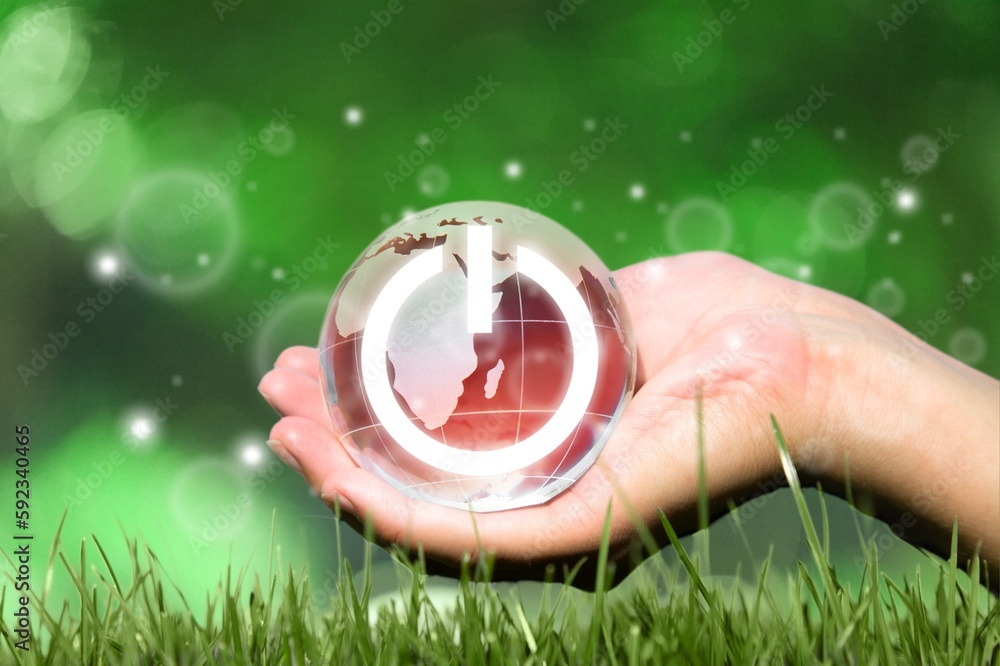 Wall mural globe of earth with image of power button in hand