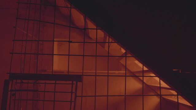 Empty jail cell. Prison. Horror or halloween concept. Orange electric light. Shadows