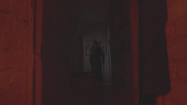 Homicidal maniac like from horror movies is standing in the hallway. the light changes. halloween or horror idea. the light is flickering. high quality FullHD footage with slow motion. 