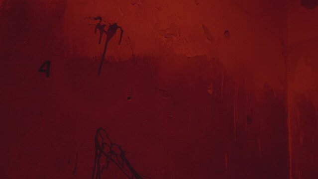 Number 666 is written on a brick wall. Horror abandoned house concept. Red paint. Flickering light