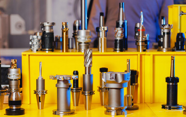 Set new drills and cutters for automatic metal processing CNC machine. Industrial tool equipment for iron factory