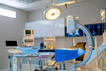 Close up empty operation room with no people and view through clear mirror contain light and tools and instrument to support for treatment the patient.