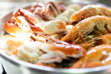 Steam blue crab legs and shrimp on food steamer.