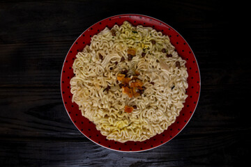 Instant vermicelli in a plate with seasoning.
