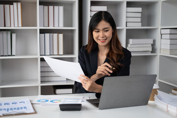 Young beautiful businesswoman working in the modern office room. sitting at her office desk.