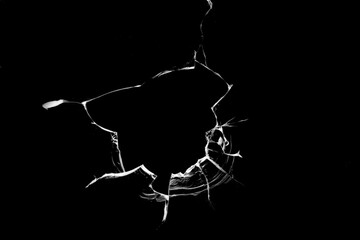 Concept of broken glass with hole for design on black background.