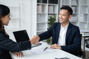 Fototapeta premium Smiling manager shaking hands with an applicant after an interview.