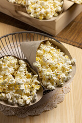 Eco-friendly paper cones filled with popcorn inside a vintage bowl.