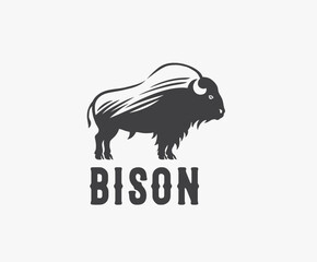 Symbol of the silhouette of a bison (bull), in the form of standing on his feet and looking forward. Vector illustration. © Rustic