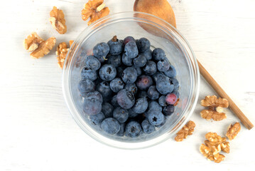 Plastic bowl with blueberries and walnuts