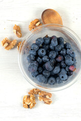 Plastic bowl with blueberries and walnuts